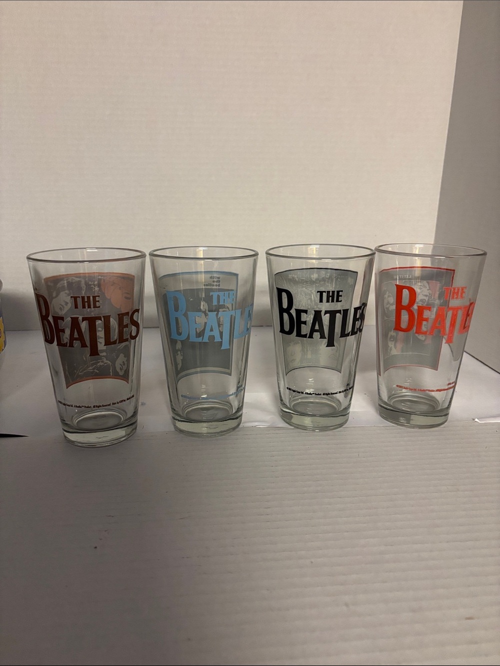 The Beatles Colored Logo Pint Glass Set - Red, Blue, Black, Brown